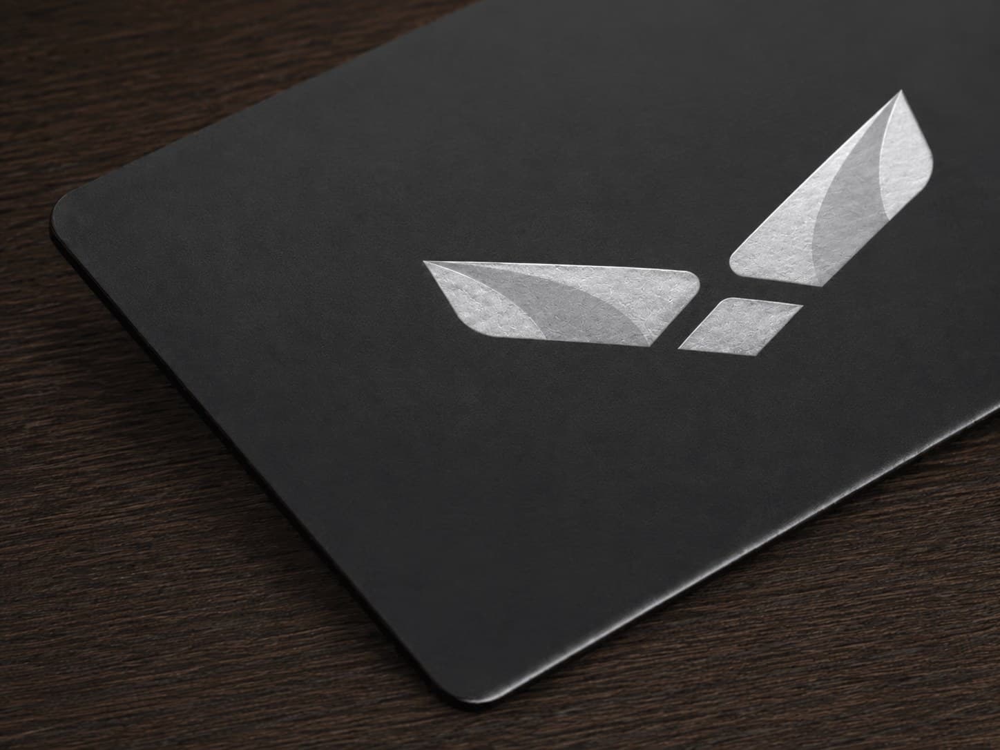 The metal card lying on a dark wooden surface